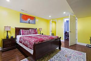 a bedroom with a bed with a red comforter at Beautiful 2 bedroom 1 bath Unit in Alexandria