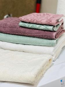 a pile of towels sitting on top of a table at Stan na dan "Apartman Purple" in Banja Luka