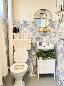 a bathroom with a toilet and a sink and a mirror at Roemah lily studio in Tanah Rata
