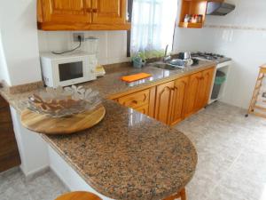 a kitchen with a counter top with a microwave at La Estancia en La Frontera El Hierro in Frontera