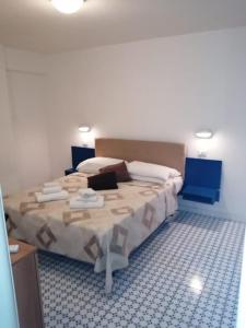 a bedroom with a large bed in a room at Camere e appartamenti con ingresso indipendente Hotel Le Terrazze in Riccione