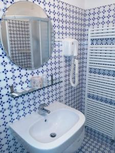 a bathroom with a white sink and a mirror at Camere e appartamenti con ingresso indipendente Hotel Le Terrazze in Riccione