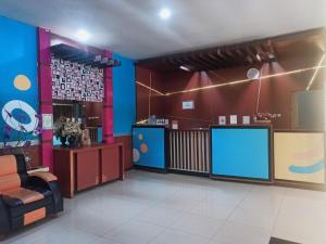 a waiting room with blue and red walls at City Inn Antang in Palangkaraya