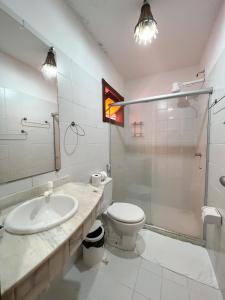 a bathroom with a sink and a toilet and a shower at Chez Max Pousada in Morro de São Paulo
