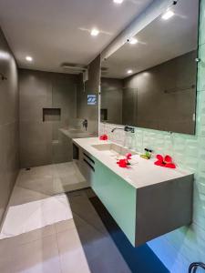 een badkamer met een wastafel en een grote spiegel bij Chez Max Pousada in Morro de São Paulo