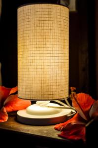 a white lamp sitting on top of a table at Chez Max Pousada in Morro de São Paulo