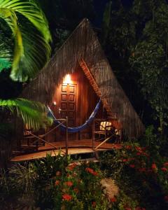 a small bamboo house with a light on it at Chez Max Pousada in Morro de São Paulo