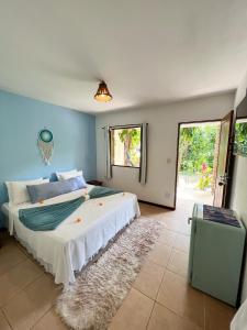 a bedroom with a large bed in a room at Chez Max Pousada in Morro de São Paulo