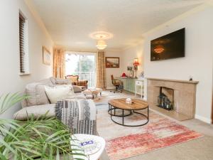 a living room with a couch and a fireplace at Kempton in Bowness-on-Windermere