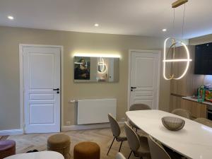 a dining room with a white table and chairs at Disney cottage in Coupvray