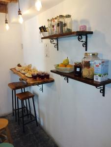 a room with shelves on the wall with food at Hostel Piltri in El Bolsón