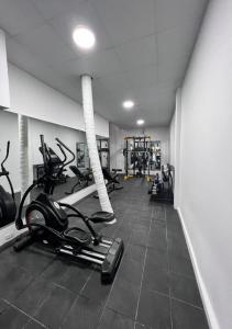 a gym with treadmills and elliptical machines at Hotel El Bosque in Jaén