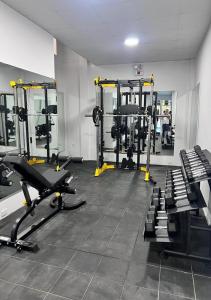 a gym with several tread machines in a room at Hotel El Bosque in Jaén
