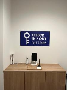 a sign on top of a desk in an office at Second Home 瀬戸風月 in Takamatsu