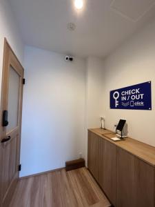 an office with a desk and a sign on the wall at Second Home 瀬戸風月 in Takamatsu