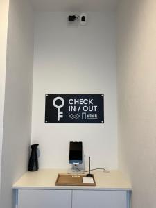 a desk with a computer and a sign on a wall at Second Home 瀬戸風月 in Takamatsu