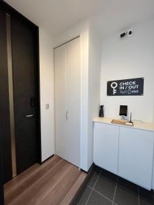 a room with a door and a desk with a computer at Second Home 瀬戸風月 in Takamatsu