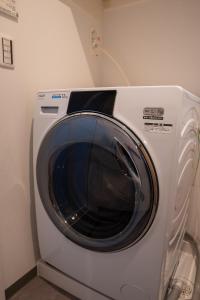 a washing machine is sitting in a room at Second Home 瀬戸風月 in Takamatsu