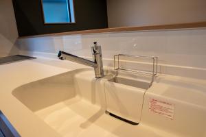 a sink with a faucet on top of a counter at Second Home 瀬戸風月 in Takamatsu