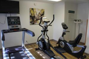 two exercise bikes in a room with a tv at Days Inn by Wyndham Bend in Bend
