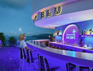 a woman standing at a bar in a restaurant at Holi Panorama Condotel in Nha Trang