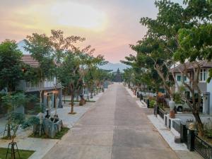 an empty street in a town with houses at Happy Land Residence in Ban Nam Cham