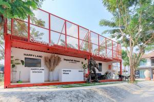 a building with a red frame and a sign that reads happy land at Happy Land Residence in Ban Nam Cham