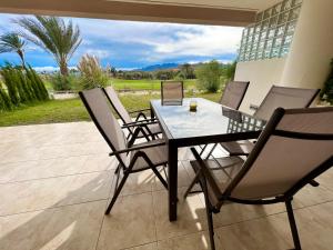 a dining table and chairs on a patio at Destino Deluxe Valle del Este Vera in Vera