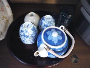 a black plate with blue and white vases on a table at Nikko PRIVATE INN WA NODOKA in Nikko