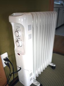a row of white radiators sitting next to a wall at Nikko PRIVATE INN WA NODOKA in Nikko