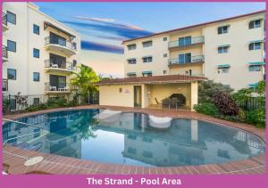 a swimming pool in front of a building at Strand Park Unit - U1 Ground floor in Townsville