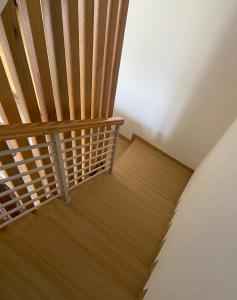 una escalera de madera en una casa con suelo de madera en Green Apple Villa, en Batu