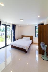 a bedroom with a bed and a large window at Đà Lạt Cao Nguyên Hotel in Da Lat