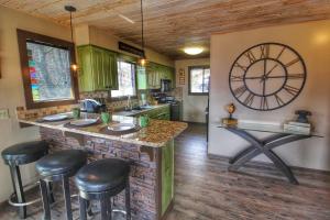 a kitchen with a large clock on the wall at Paradise Vista, Amazing Mtn Views, Hot Tub, 560 FREE tickets each paid day!!! in Gatlinburg