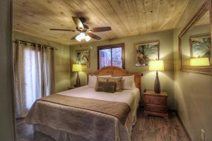 a bedroom with a bed and a ceiling fan at Paradise Vista, Amazing Mtn Views, Hot Tub, 560 FREE tickets each paid day!!! in Gatlinburg +33 photos