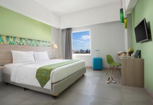 Postel nebo postele na pokoji v ubytování KHAS Makassar Hotel + 22 fotografií