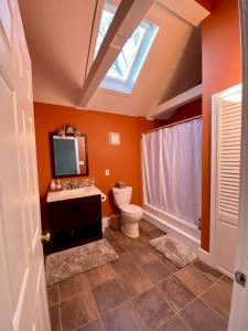 a bathroom with a toilet and a tv on the ceiling at Peddlers Carriage house in New Hope