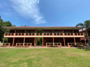 a large building with a lawn in front of it at PANGKOR PURNAMA CHALET in Pangkor