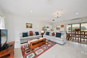 a living room with two couches and a table at Talga Estate in Lovedale