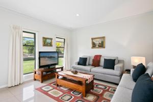 a living room with a couch and a tv at Talga Estate in Lovedale
