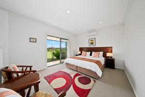 a bedroom with a bed and a large window at Talga Estate in Lovedale