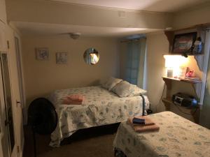 a small bedroom with two beds and a mirror at Queen Anne's Revenge at the Beach cottage in Kitty Hawk