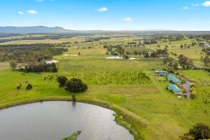 an aerial view of a farm with a lake at Talga Estate in Lovedale