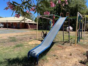 a playground with a slide in a park at Philadelphia Motor Inn in Echuca