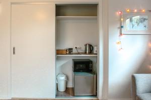 a small kitchen with a microwave and a small refrigerator at Wanaka Riverside 1 Bedroom Apartment in Wanaka
