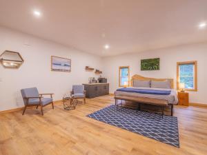 a bedroom with a bed and a blue rug at Winter's Hideaway Suite in Ucluelet