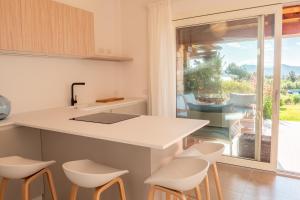 a kitchen with a counter with stools and a table at Villa Valentina 250m From The Beach - Happy Rentals in Puntaldia