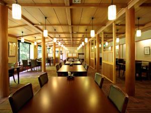 a conference room with tables and chairs and lights at Kose Onsen in Karuizawa