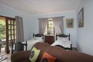 a living room with two beds and a couch at Xanadu Guest House in Sea Park