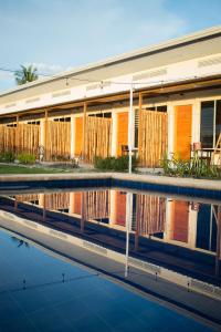 a building with orange doors and a swimming pool at Manta Dream Resort in Panglao